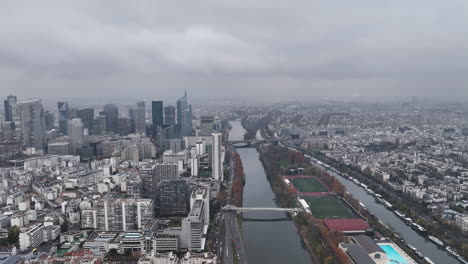 Aerial-view-of-La-Défense,-Paris's-modern-hub,-under-a-cloudy-sky.